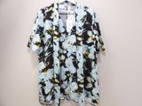 a black and yellow floral shirt hanging on a hanger
