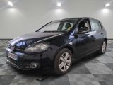 the black volkswagen golf is parked on a checkered tile floor