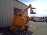 a yellow crane that is parked in front of a building