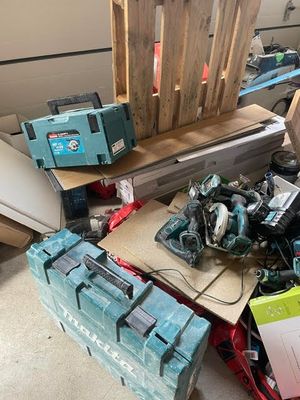 a pile of tools sitting on the floor in a garage