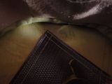 a close up of a wallet with a tie on it