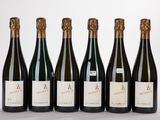 six bouteilles de vin sont alignées sur une table