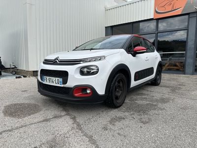 a white citrole parked in front of a building