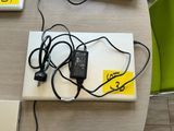 a laptop computer sitting on a table with a charger