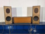 three speakers that are sitting on top of a blue table