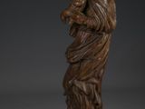 a wooden statue of a woman holding a child in her arms