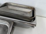 two trays of food sitting on a counter