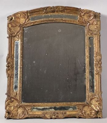 an image of a gold framed mirror sitting on top of a white wall