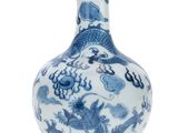 a blue and white vase with a dragon design on it