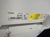 a close up of a canon printer with a yellow sticker on it