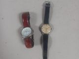 two watches sitting next to each other on a table