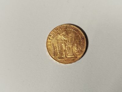 a gold coin with an image of a man and a woman on it