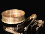 a gold ring and a silver ring on a black surface