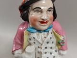 a figurine of a clown with a hat on