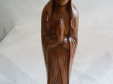 wooden statue of a woman holding a baby in her arms