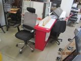 a desk with a computer and a chair in a room