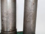 two metal cylinders that are sitting on a table