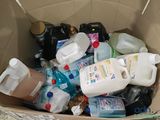 une boîte en carton remplie de bouteilles et de flacons de produits d'entretien