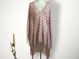 the sweater is pink and white with fringes on a mannequin stand