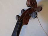 a close up of a violin with a string attached to it