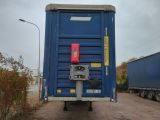 a blue trailer that is parked on the side of the road