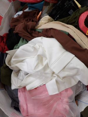a basket full of clothes that is sitting on the floor