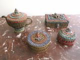 three decorative boxes sitting on top of a table next to each other