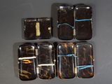 six cell phones are lined up in a row on a table