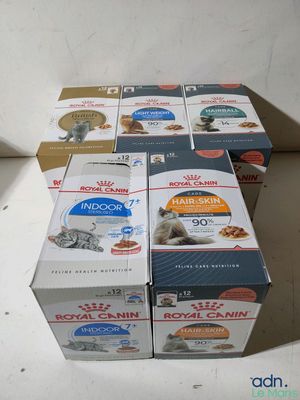several boxes of cat food sitting on top of a white counter