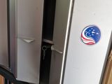 a refrigerator that has a sticker on it in a kitchen