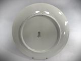 a white plate with a crown on it sitting on a table
