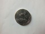 a close up of a silver coin on a white surface