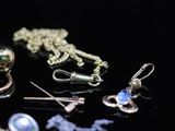 many different types of jewelry on a black surface