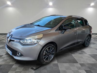 a silver car parked in a garage with a checkered floor