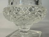 a glass vase that is sitting on a glass stand