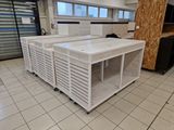 a white kitchen island in the middle of a tiled floor
