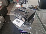 a small projector sitting on top of a glass table