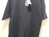 a black t - shirt hanging on a hanger with a tag on it