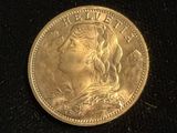 a close up of a gold coin with a woman ' s face on it