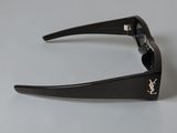 black sunglasses with a gold monogram on the side of the glasses