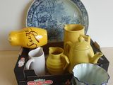 une boîte sur laquelle sont posés une assiette, des tasses et une carte