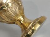 a gold vase that is sitting on a table