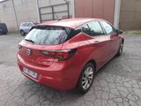 a red car that is parked in a parking lot