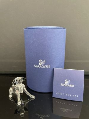 une petite figurine d'éléphant à côté d'une boîte bleue