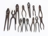 several different types of pliers are lined up on a white surface
