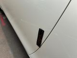 a close up of a car door with a sticker on it