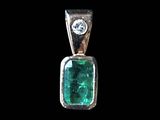 a close up of a pendant with a green stone and a diamond