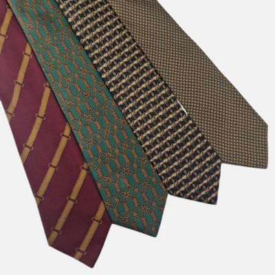 three different colored ties are stacked on top of each other