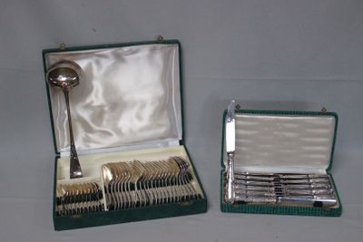 silverware in a green case with a spoon and spoon rest in it