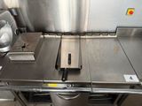 a metal table with a knife on it in a kitchen